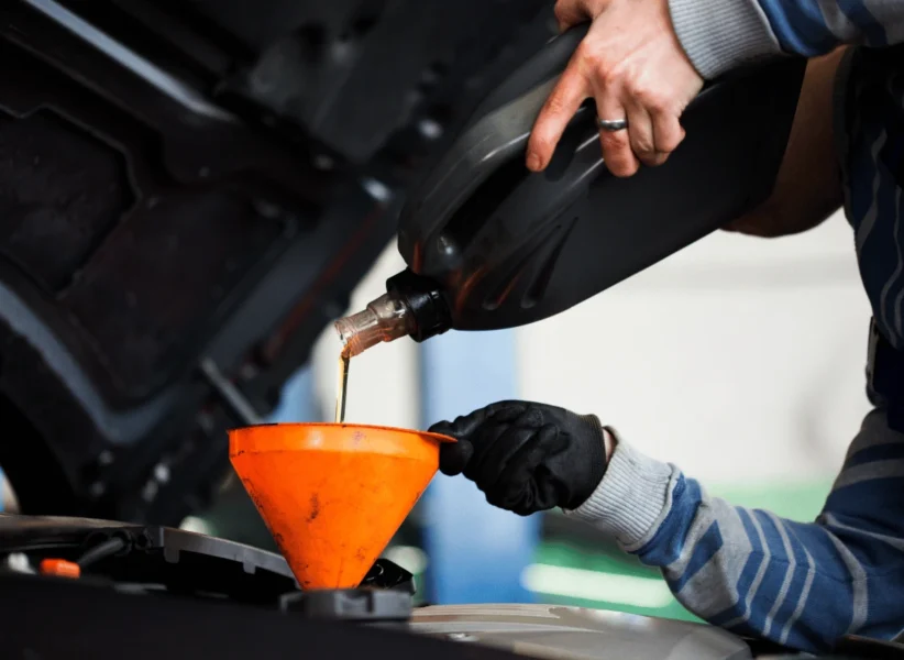 Mechanic performing oil change on diesel truck in Edmonton