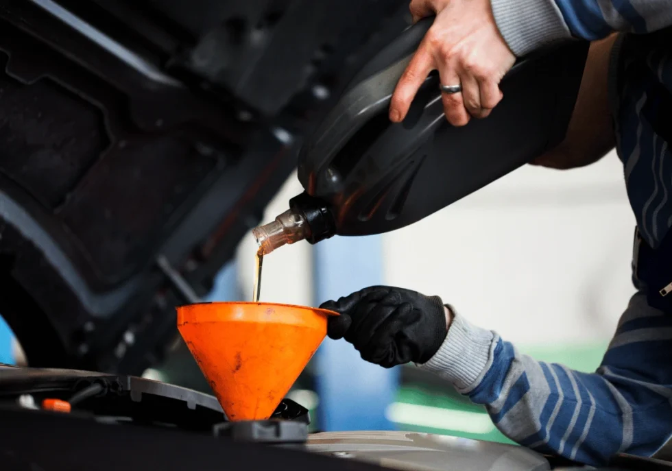 Mechanic performing oil change on diesel truck in Edmonton