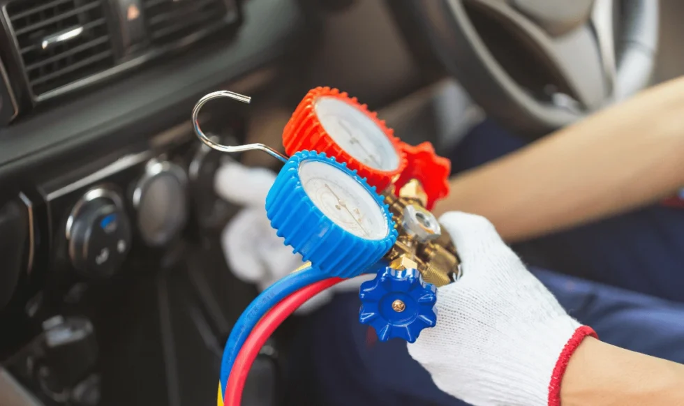 checking car AC Technician checking car AC pressure with manifold gauge in Edmonton