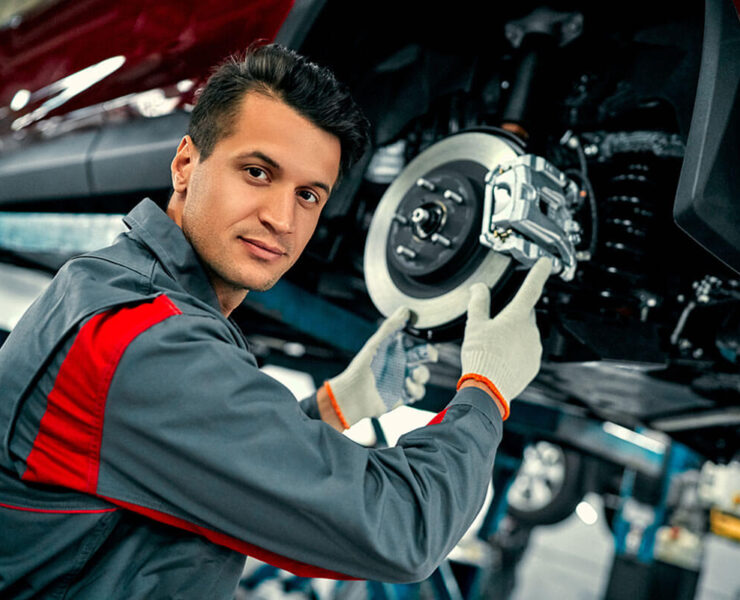 Mechanic replacing brake pads on diesel truck in Edmonton