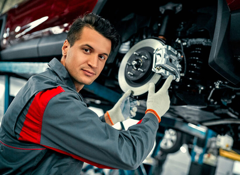 Mechanic replacing brake pads on diesel truck in Edmonton