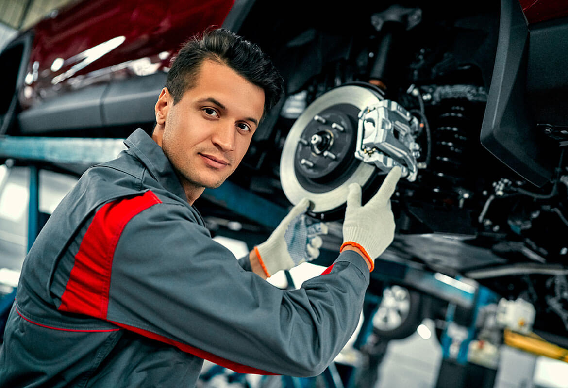 Mechanic replacing brake pads on diesel truck in Edmonton