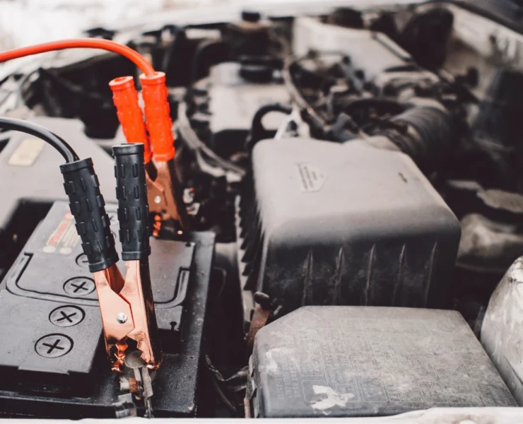 Technician testing a car battery with diagnostic tool in Edmonton