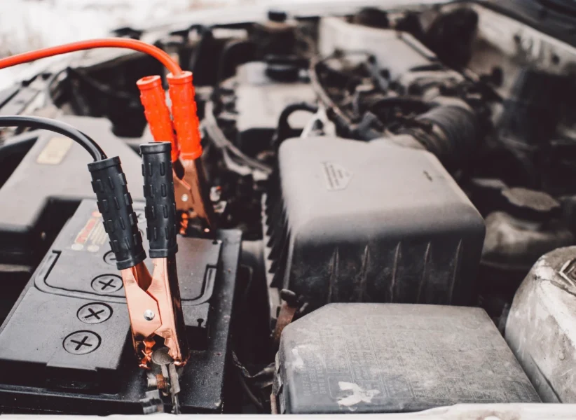 Technician testing a car battery with diagnostic tool in Edmonton
